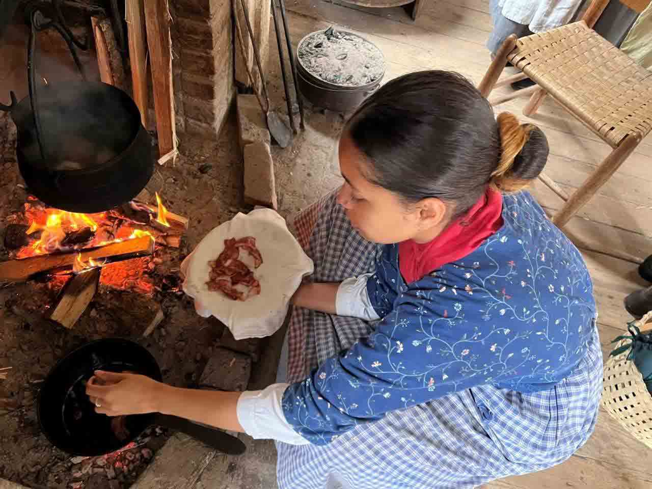 19th century woman cooking bacon